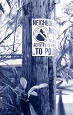 Neighborhood watch sign on a wooden pole
