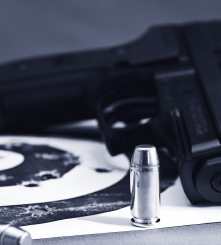 Bullet with gun in background