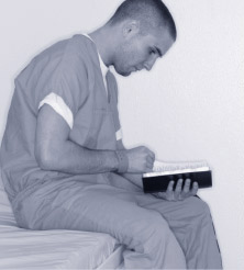 Man reading in a cell