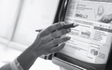 Hand pointing at a computer screen