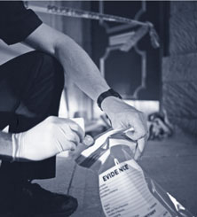 Crime scene tech putting evidence in a bag