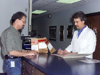 Image of police recording details in the chain of custody record