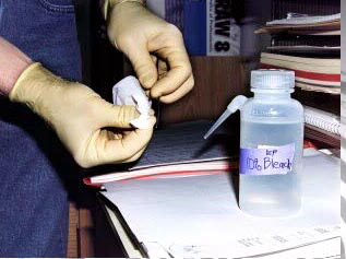 Image of technician cleaning re-usable implements