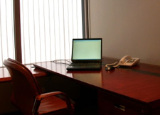 Photo of an old laptop on a hotel room desk