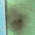 Photo of gunpowder residue on a piece of fabric