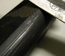 Close up photo of a gun with small marks on it