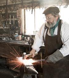 Photo of a man hammer forging