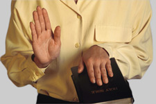 Photo of someone being sworn in to court