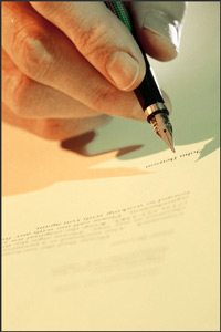 A pen about to write on a piece of paper