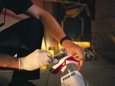 a man putting something into an evidence bag