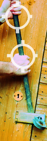 Photo of a man with crowbar prying a lock open