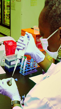 photo of a lab technician filling a test tube