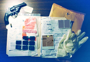 Collage of a gun, rubber gloves, case file, photographs