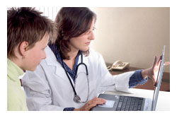 A doctor and child looking at a computer screen