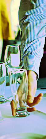 photo of a man picking up a drinking glass