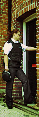British Police officer knocking on a door