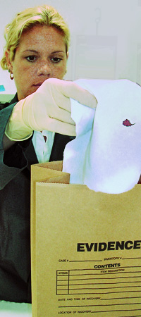 Woman putting piece of evidence in a bag
